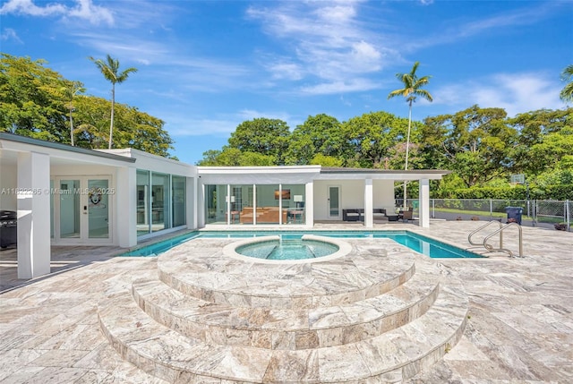 11230 SW 69th Ct, Pinecrest, FL 33156 - view of swimming pool with an in-ground hot tub, a patio area, and french doors