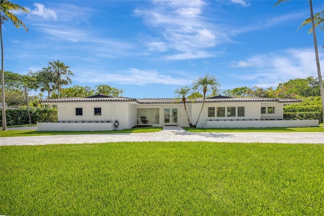 11230 SW 69th Ct, Pinecrest, FL 33156 - view of front of house with french doors, stucco siding, a front yard, and a tiled roof