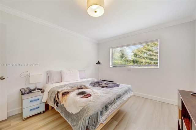 11230 SW 69th Ct, Pinecrest, FL 33156 - bedroom with light wood-style floors and ornamental molding