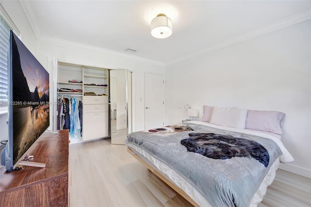 11230 SW 69th Ct, Pinecrest, FL 33156 - bedroom with light wood finished floors, ornamental molding, and a closet