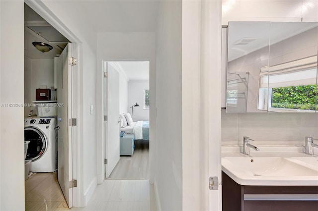 11230 SW 69th Ct, Pinecrest, FL 33156 - ensuite bathroom with washer / dryer, healthy amount of natural light, ornamental molding, and vanity