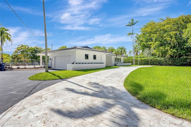 11230 SW 69th Ct, Pinecrest, FL 33156 - view of front of property with decorative driveway, stucco siding, a garage, and a tile roof