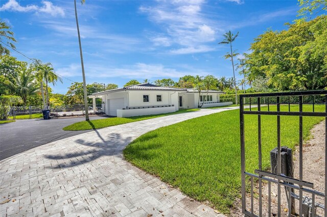 11230 SW 69th Ct, Pinecrest, FL 33156 - view of front of property with curved driveway, a garage, stucco siding, and a tile roof