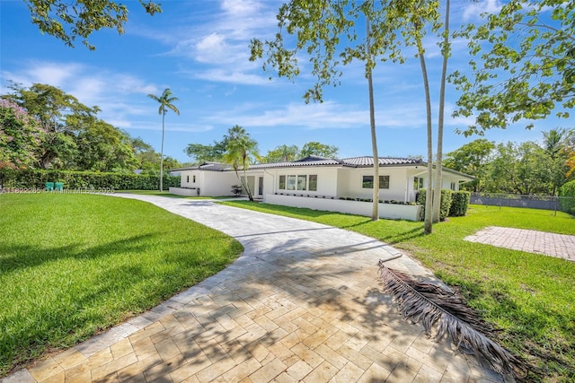 11230 SW 69th Ct, Pinecrest, FL 33156 - view of front facade with stucco siding, a tiled roof, and driveway