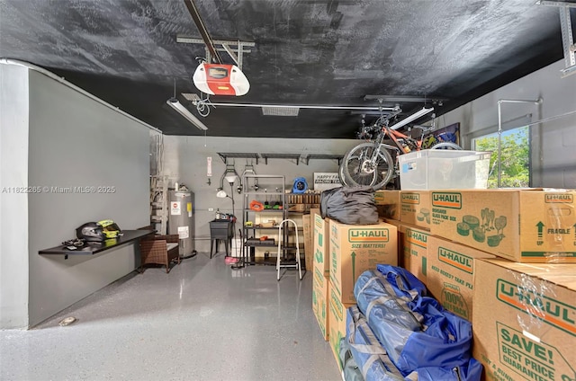 11230 SW 69th Ct, Pinecrest, FL 33156 - garage with a garage door opener and water heater