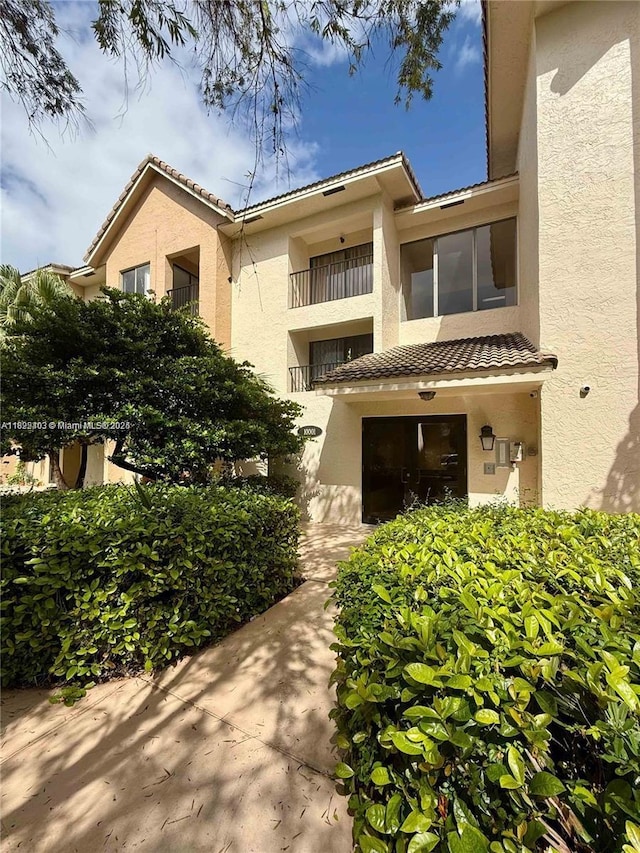 10001 W Atlantic Blvd Unit 321, Coral Springs, FL 33071 - view of front of home featuring stucco siding and a tiled roof