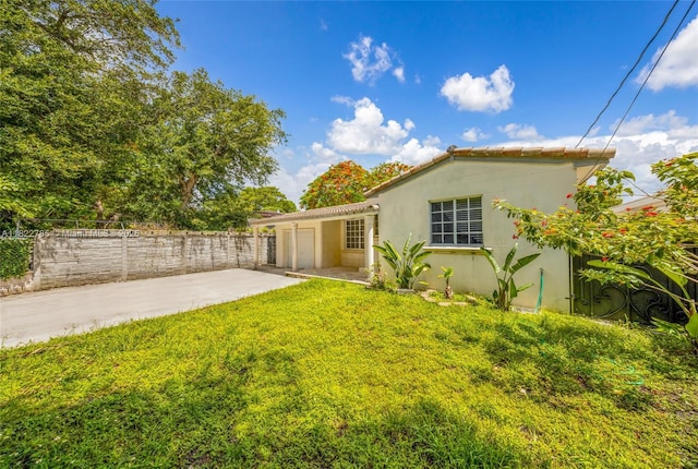 5781 SW 25th St, Miami, FL 33155 - view of yard with concrete driveway, a garage, and a patio