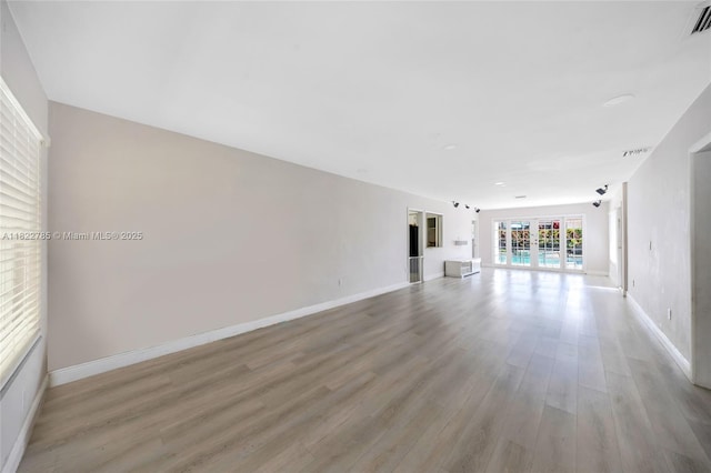 5781 SW 25th St, Miami, FL 33155 - unfurnished living room featuring wood finished floors and baseboards
