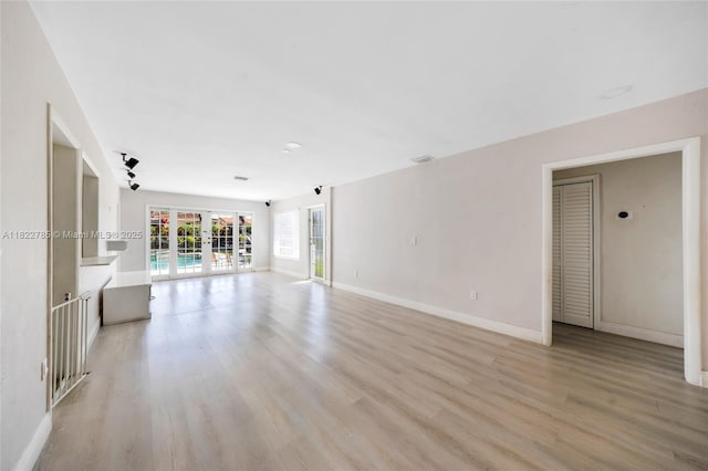 5781 SW 25th St, Miami, FL 33155 - unfurnished living room featuring french doors and light wood-type flooring