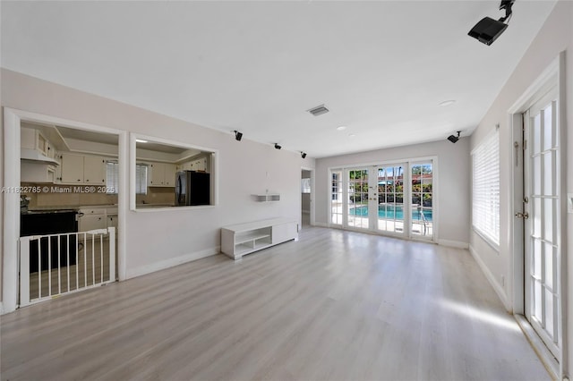 5781 SW 25th St, Miami, FL 33155 - unfurnished living room with light wood finished floors and french doors