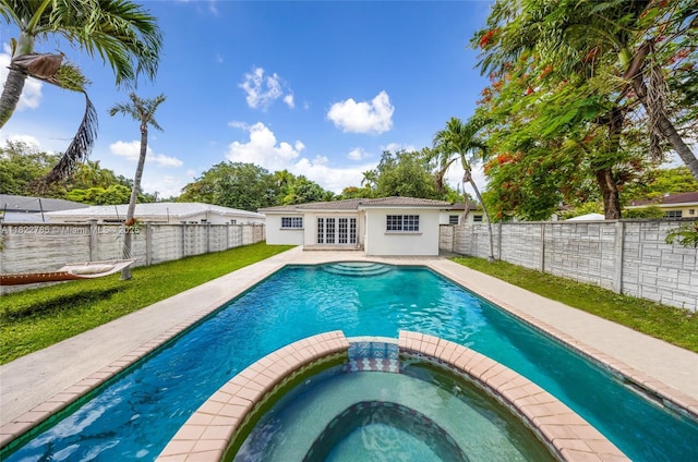 5781 SW 25th St, Miami, FL 33155 - view of swimming pool with a pool with connected hot tub, a fenced backyard, an outbuilding, and an exterior structure