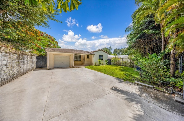 5781 SW 25th St, Miami, FL 33155 - view of front of property with stucco siding, driveway, an attached garage, and a tiled roof