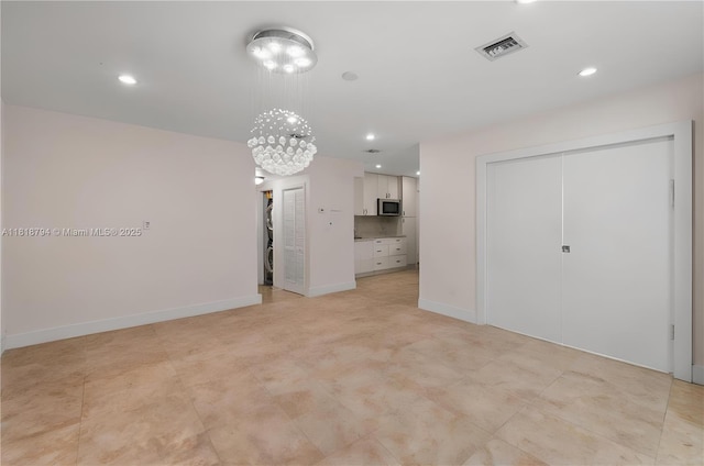 1601 Bay Rd Unit 4, Miami Beach, FL 33139 - unfurnished living room featuring a chandelier and recessed lighting