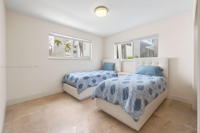1601 Bay Rd Unit 4, Miami Beach, FL 33139 - bedroom with baseboards and light tile patterned flooring