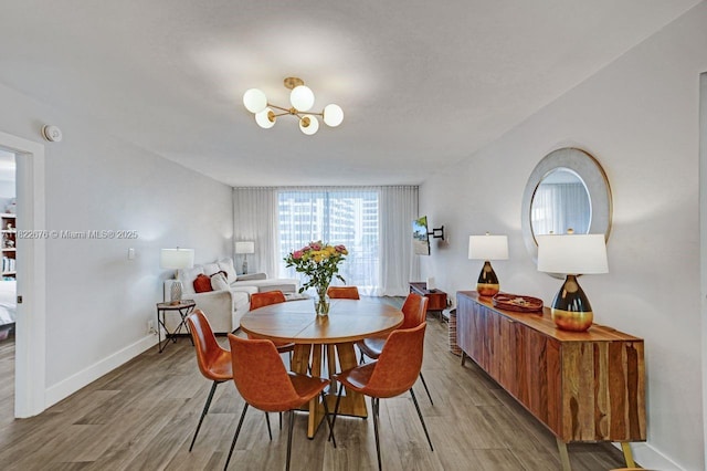 600 Three Islands Blvd Unit 615, Hallandale Beach, FL 33009 - dining room featuring a chandelier and wood finished floors