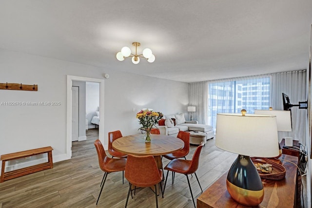 600 Three Islands Blvd Unit 615, Hallandale Beach, FL 33009 - dining area featuring a chandelier and wood finished floors