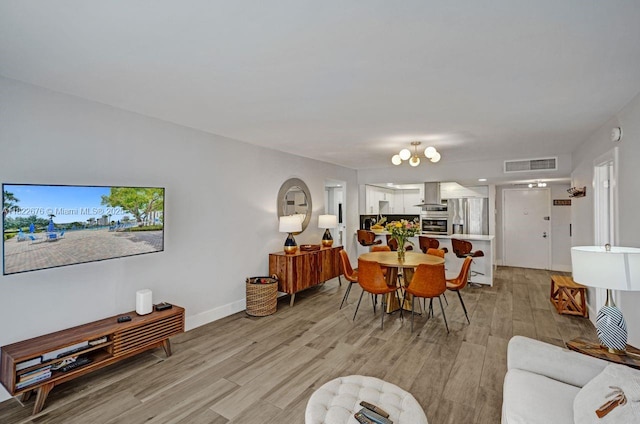 600 Three Islands Blvd Unit 615, Hallandale Beach, FL 33009 - living area with light wood-style flooring, healthy amount of natural light, and a chandelier