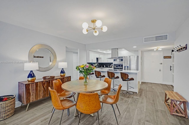 600 Three Islands Blvd Unit 615, Hallandale Beach, FL 33009 - dining room featuring a chandelier and light wood finished floors