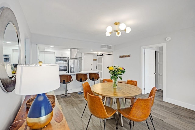 600 Three Islands Blvd Unit 615, Hallandale Beach, FL 33009 - dining room with light wood-style flooring, a chandelier, and recessed lighting