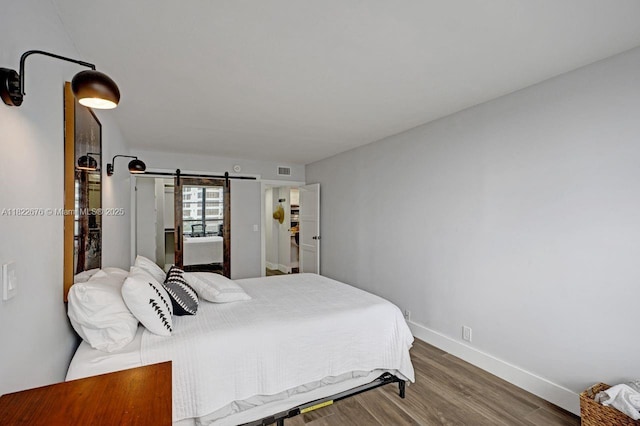 600 Three Islands Blvd Unit 615, Hallandale Beach, FL 33009 - bedroom with wood finished floors and a barn door