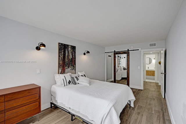 600 Three Islands Blvd Unit 615, Hallandale Beach, FL 33009 - bedroom with a barn door and wood finished floors
