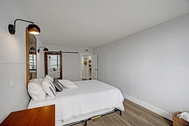 600 Three Islands Blvd Unit 615, Hallandale Beach, FL 33009 - bedroom with wood finished floors and a barn door