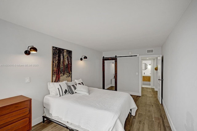 600 Three Islands Blvd Unit 615, Hallandale Beach, FL 33009 - bedroom with a barn door and wood finished floors