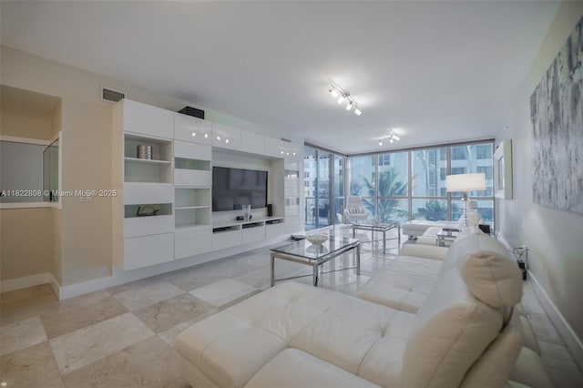 3101 S Ocean Dr Unit 404, Hollywood, FL 33019 - living room featuring baseboards and expansive windows