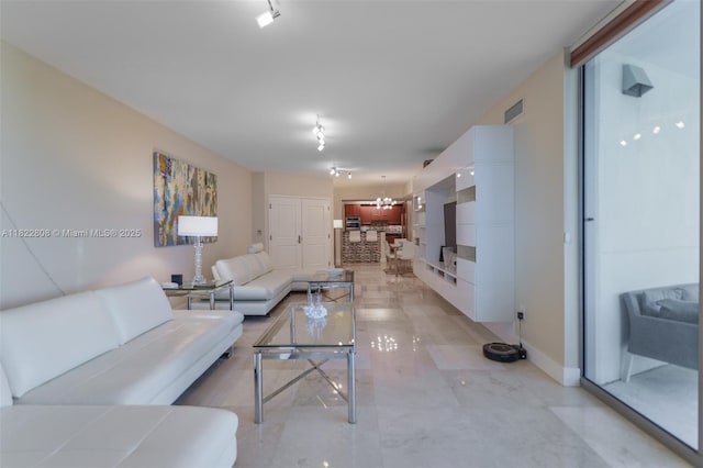 3101 S Ocean Dr Unit 404, Hollywood, FL 33019 - living area featuring baseboards and a chandelier