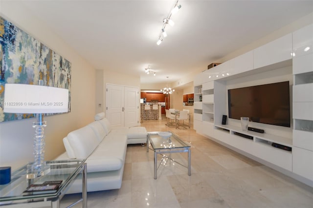 3101 S Ocean Dr Unit 404, Hollywood, FL 33019 - living room featuring a chandelier, built in shelves, and rail lighting