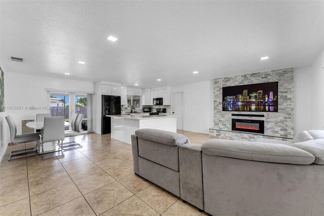 27645 SW 163rd Ave, Homestead, FL 33031 - living room with light tile patterned floors, recessed lighting, and a fireplace