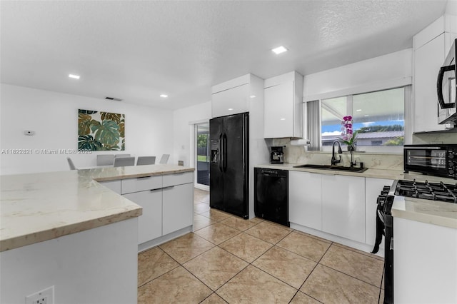 27645 SW 163rd Ave, Homestead, FL 33031 - kitchen featuring black appliances, white cabinets, modern cabinets, light tile patterned floors, and recessed lighting
