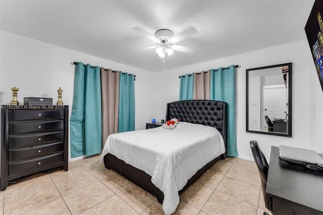 27645 SW 163rd Ave, Homestead, FL 33031 - bedroom with light tile patterned flooring, a textured ceiling, and a ceiling fan