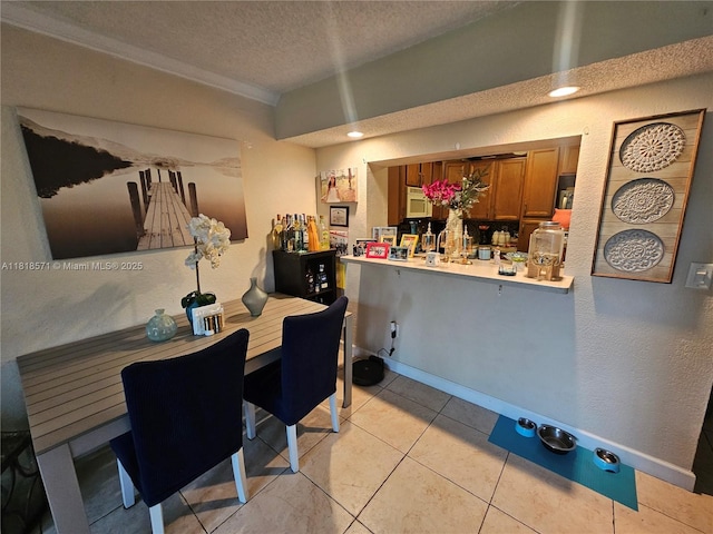 8401 W Sample Rd Unit 10, Coral Springs, FL 33065 - dining space with a textured ceiling, light tile patterned floors, a dry bar, and ornamental molding