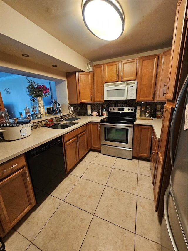 8401 W Sample Rd Unit 10, Coral Springs, FL 33065 - kitchen with stainless steel appliances, tasteful backsplash, brown cabinetry, and light countertops