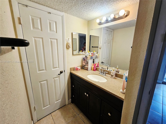 8401 W Sample Rd Unit 10, Coral Springs, FL 33065 - bathroom with tile patterned flooring, a textured ceiling, vanity, and a textured wall
