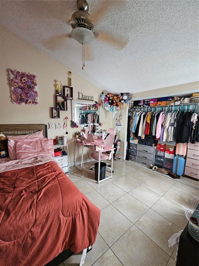 8401 W Sample Rd Unit 10, Coral Springs, FL 33065 - bedroom with a textured ceiling, tile patterned floors, vaulted ceiling, and ceiling fan