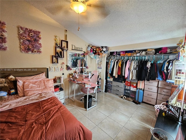 8401 W Sample Rd Unit 10, Coral Springs, FL 33065 - bedroom with a textured ceiling, tile patterned floors, vaulted ceiling, a closet, and ceiling fan