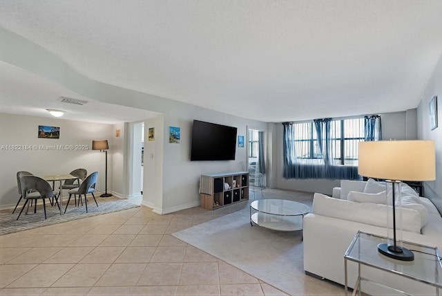 100 Golden Isles Dr Unit 101, Hallandale Beach, FL 33009 - living room with light tile patterned flooring and baseboards