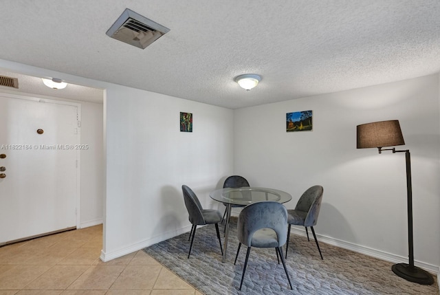 100 Golden Isles Dr Unit 101, Hallandale Beach, FL 33009 - dining area with light tile patterned floors and a textured ceiling