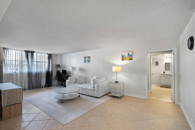 100 Golden Isles Dr Unit 101, Hallandale Beach, FL 33009 - living room featuring light tile patterned floors, a textured ceiling, and an office area