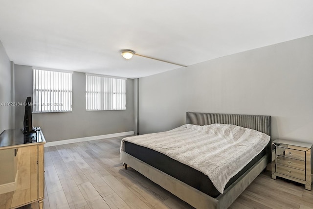 100 Golden Isles Dr Unit 101, Hallandale Beach, FL 33009 - bedroom featuring light wood-type flooring and baseboards