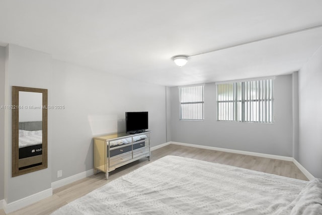100 Golden Isles Dr Unit 101, Hallandale Beach, FL 33009 - bedroom with light wood-style flooring and baseboards