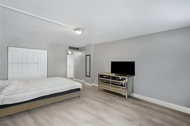 100 Golden Isles Dr Unit 101, Hallandale Beach, FL 33009 - bedroom with wood finished floors and a closet