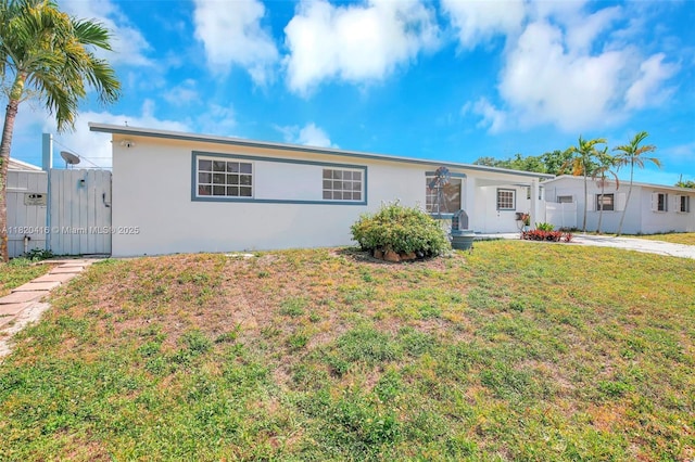 7950 NW 174th Ter, Hialeah, FL 33015 - view of front of house with a front lawn, stucco siding, and a gate