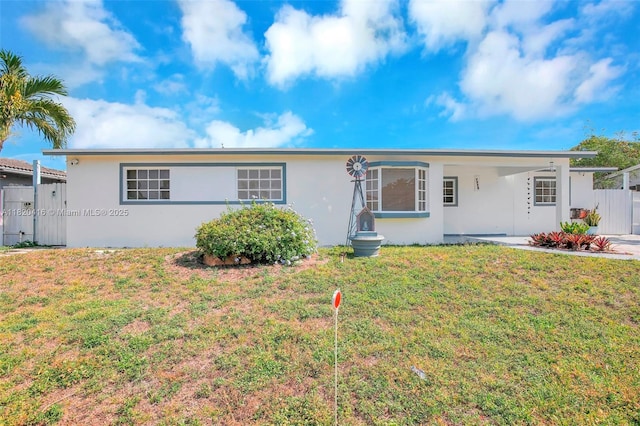 7950 NW 174th Ter, Hialeah, FL 33015 - ranch-style house with stucco siding, an attached carport, and a gate