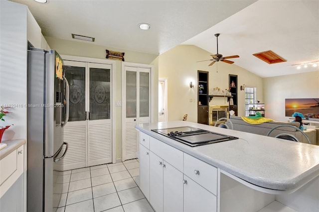 7950 NW 174th Ter, Hialeah, FL 33015 - kitchen featuring freestanding refrigerator, black electric cooktop, lofted ceiling, light countertops, and light tile patterned floors