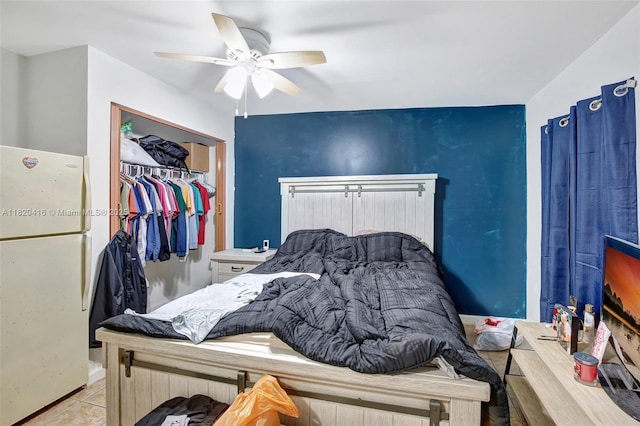 7950 NW 174th Ter, Hialeah, FL 33015 - bedroom featuring freestanding refrigerator, ceiling fan, tile patterned flooring, and a closet