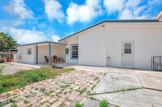 7950 NW 174th Ter, Hialeah, FL 33015 - rear view of house featuring a patio and stucco siding