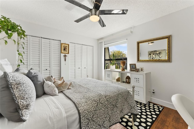 2571 NW 99th Ave, Coral Springs, FL 33065 - bedroom featuring a textured ceiling, wood finished floors, two closets, and ceiling fan